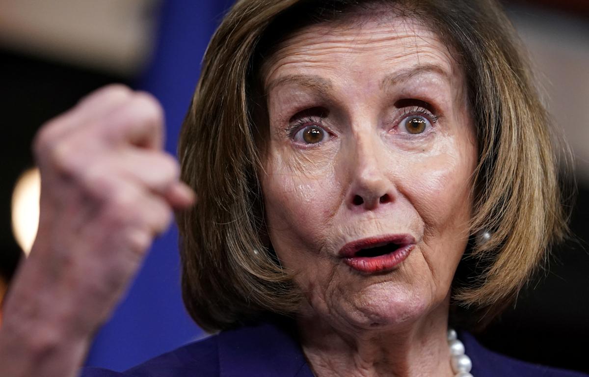 Close-up of a woman passionately speaking during a press conference, emphasizing her points with hand gestures and a focused expression.